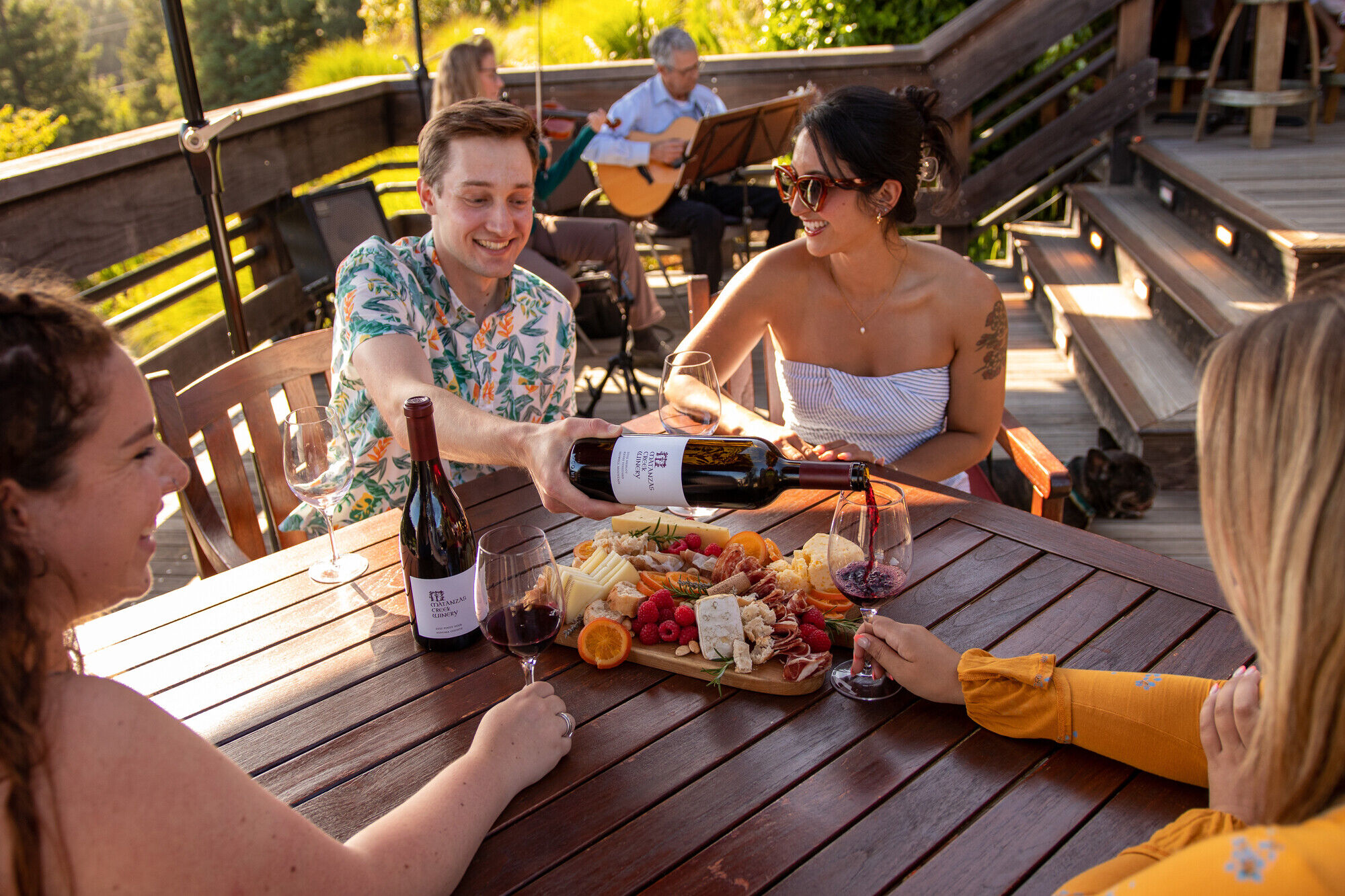 A group of friends doing a wine tasting at Matanzas Creek with charcuterie.